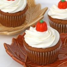 pumpkin cupcake with cream cheese frosting topped with pumpkin candy