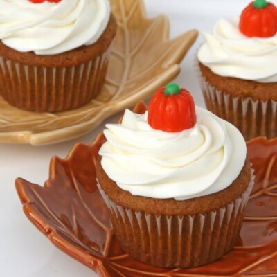 pumpkin cupcake with cream cheese frosting topped with pumpkin candy