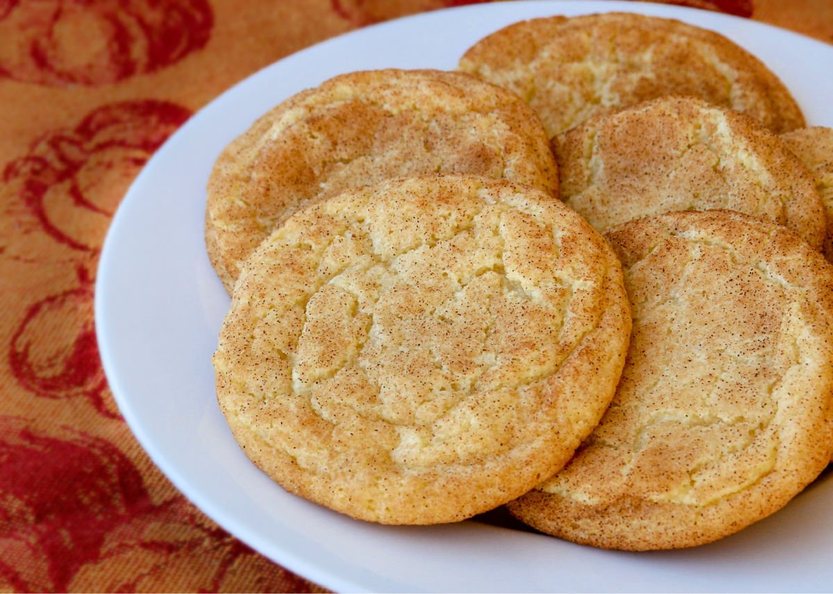 snickerdoodle cookies on white plate with orange and red napkin underneath