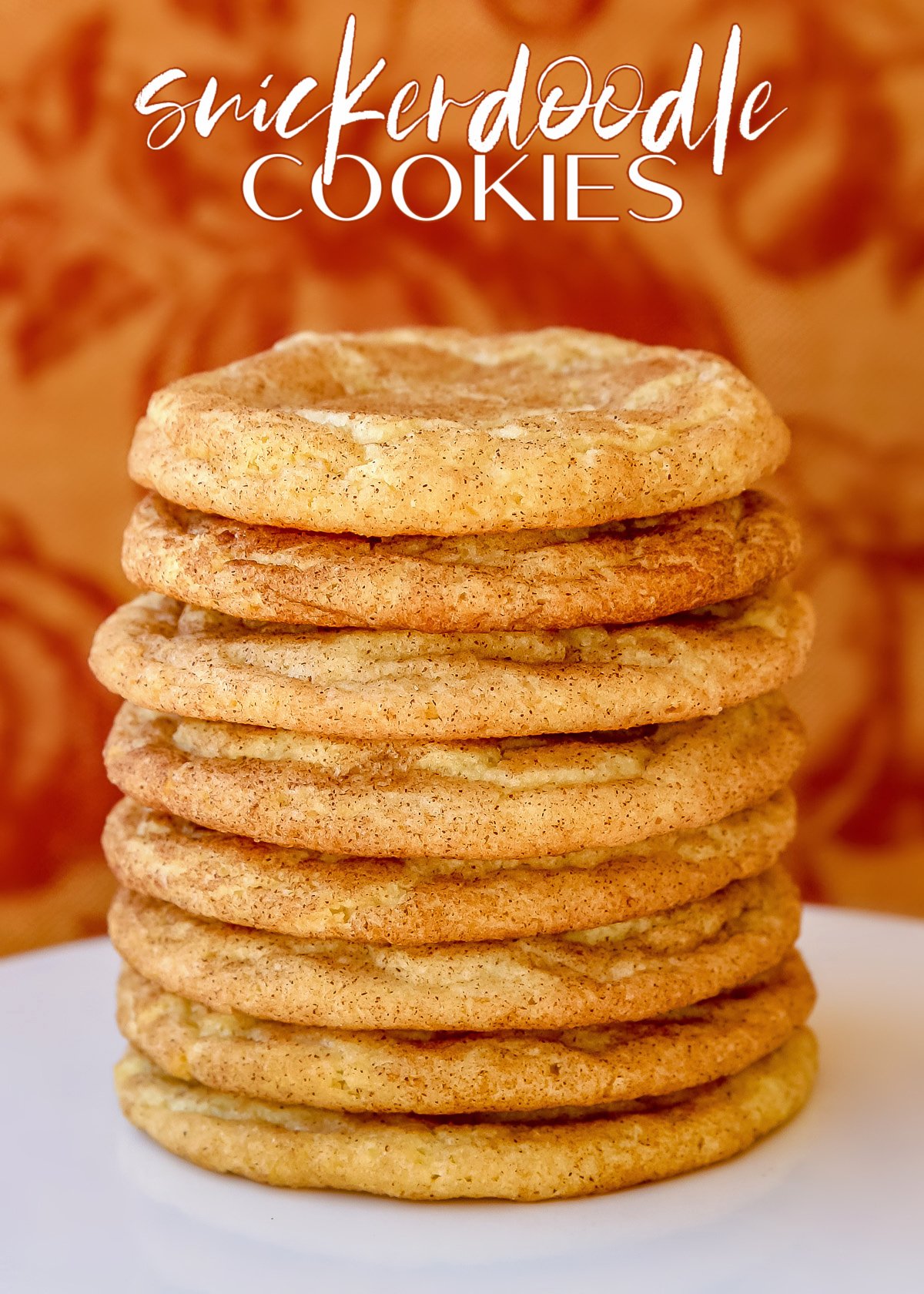 https://www.glorioustreats.com/wp-content/uploads/2010/09/snickerdoodle-cookies-stacked-high-on-white-cake-stand-with-fabric-background-and-text-overlay.jpg