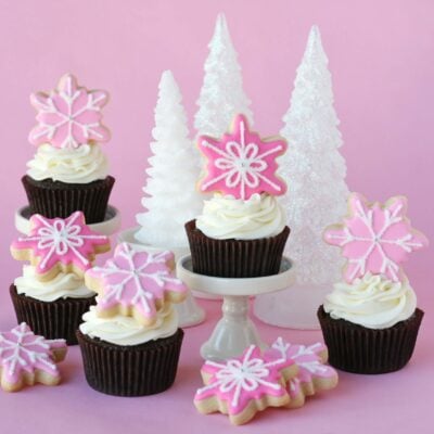 Chocolate cupcakes with cream cheese frosting decorated with a sugar cookie.