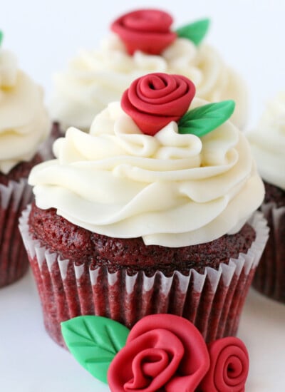 easy red velvet cupcakes with cream cheese frosting thre cupcakes on white background square