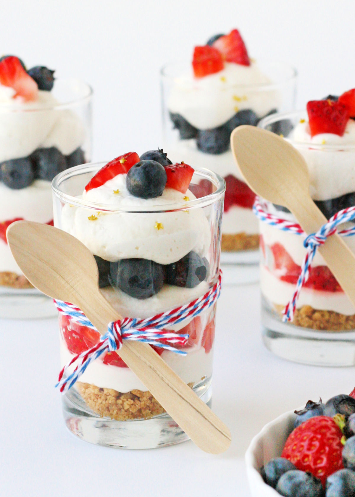 mini trifles in glasses with fresh fruit and whipped cream.