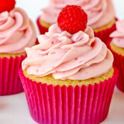 raspberry vanilla cupcakes with raspberry cream cheese frosting in pink cupcake liner square