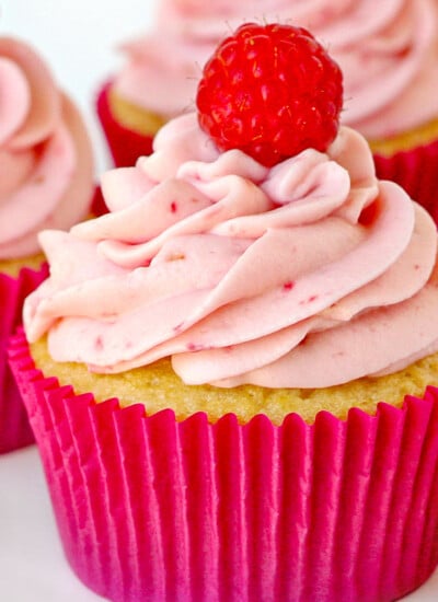 raspberry vanilla cupcakes with raspberry cream cheese frosting in pink cupcake liner square