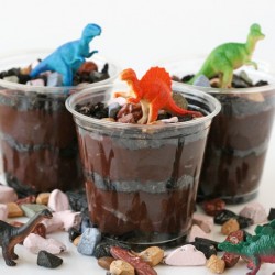 crushed Oreos and chocolate rocks topped with toy dinosaurs