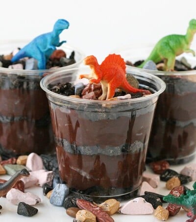 crushed Oreos and chocolate rocks topped with toy dinosaurs