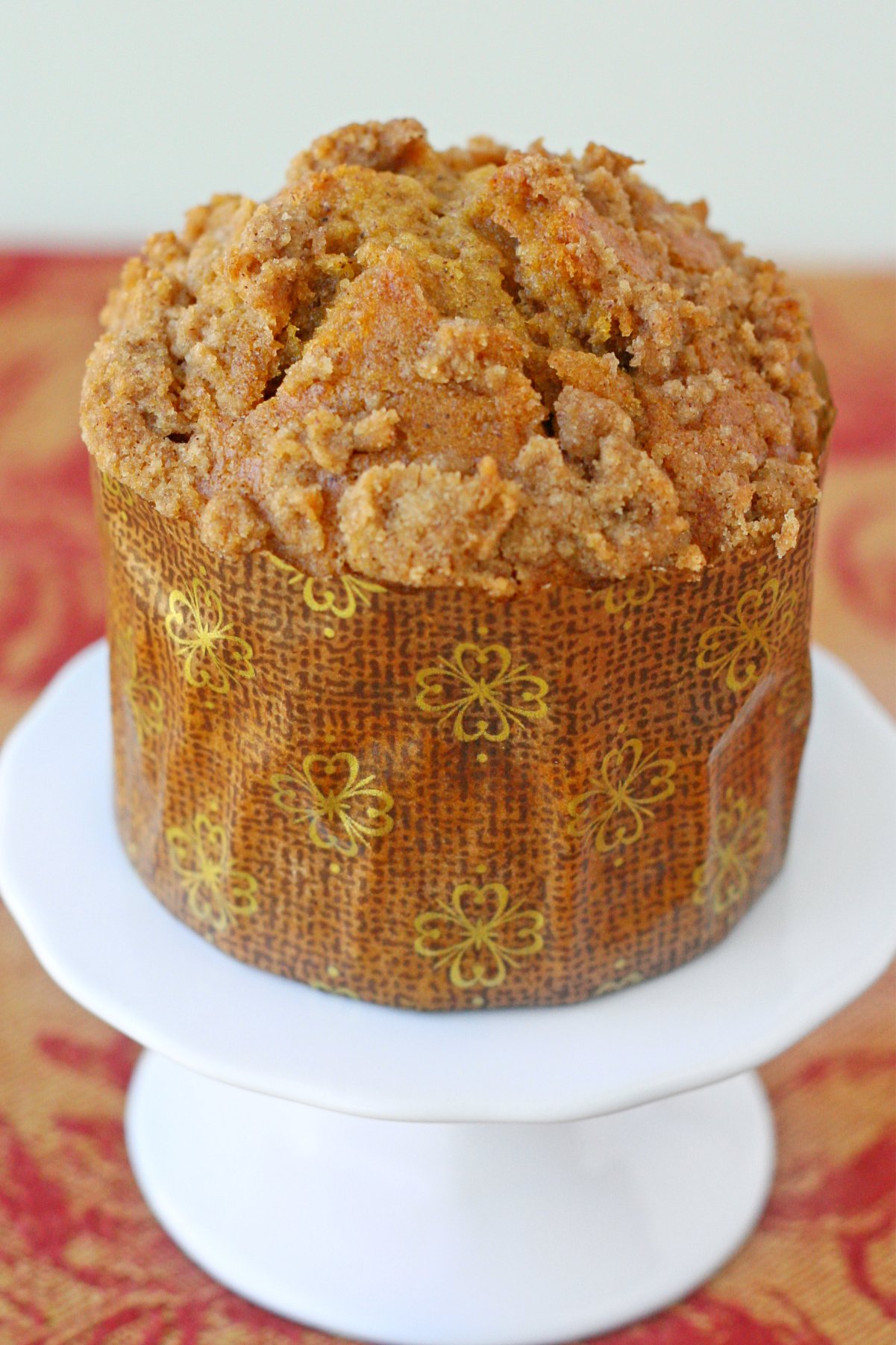 single pumpkin muffin on cupcake stand