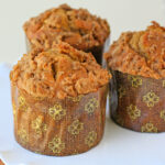 three pumpkin muffins recipe with cinnamon streusel on white cake stand