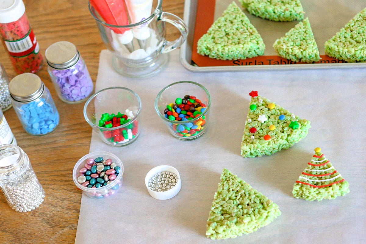rice krispie treats shaped like Christmas trees ready to be decorated.