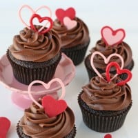 chocolate cupcakes with chocolate frosting and pink hearts