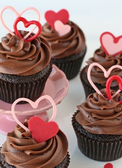 chocolate cupcakes with chocolate frosting and pink hearts