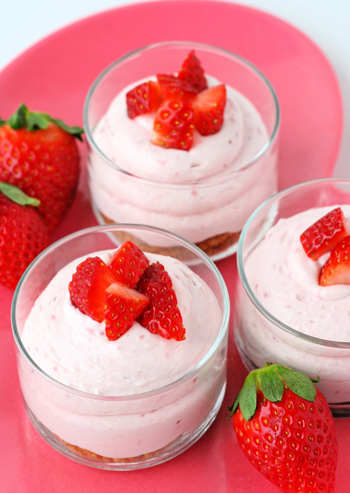 top down view of strawberry mousse on pink heart tray