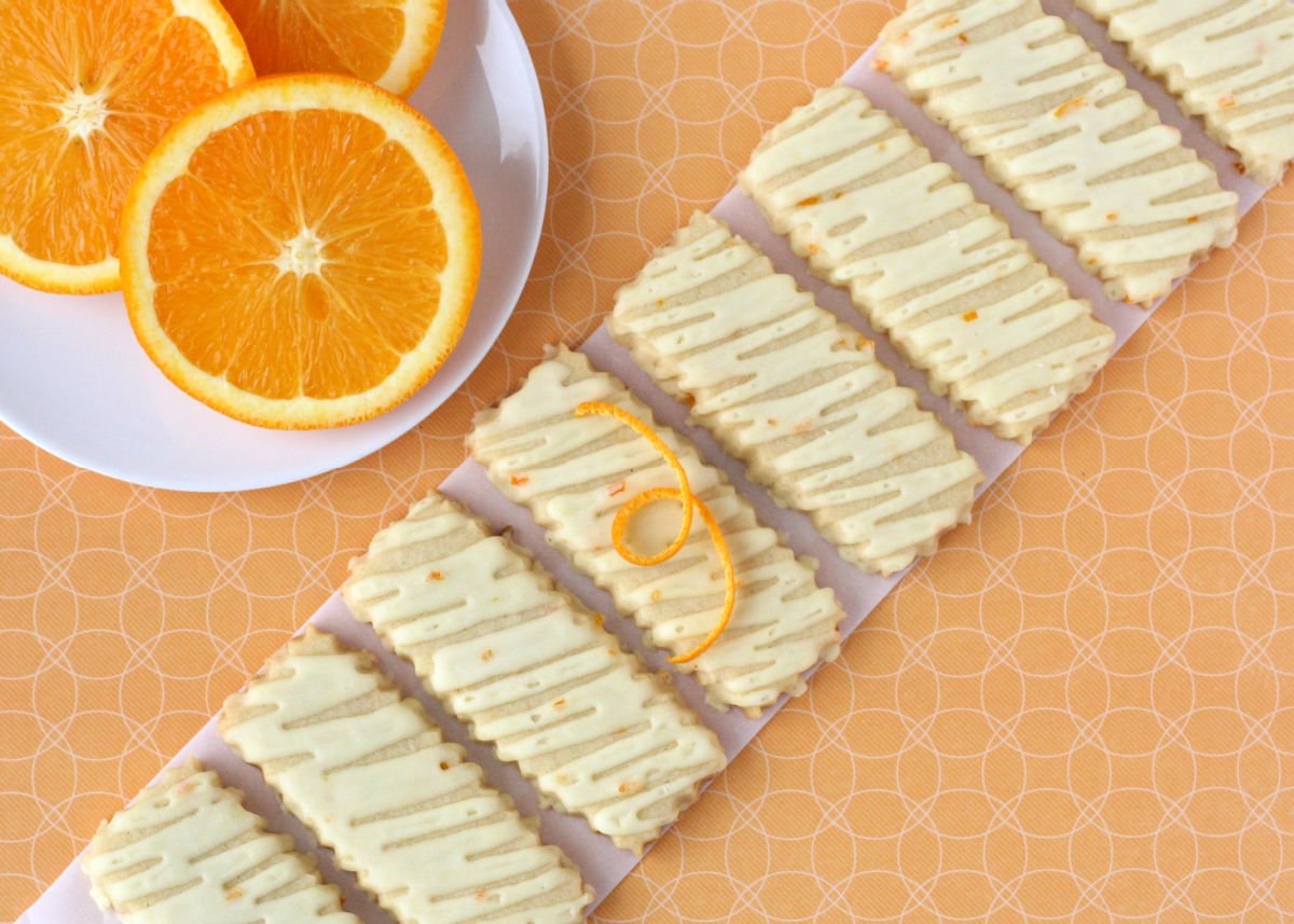 orange sugar cookies lined up in a diagonal line.