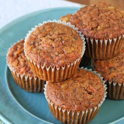 six morning glory muffins on a light blue plate.