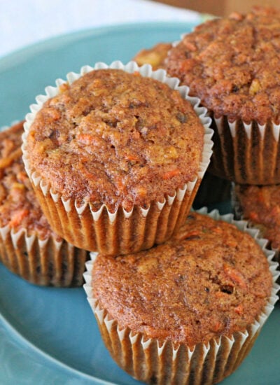 six morning glory muffins on a light blue plate.