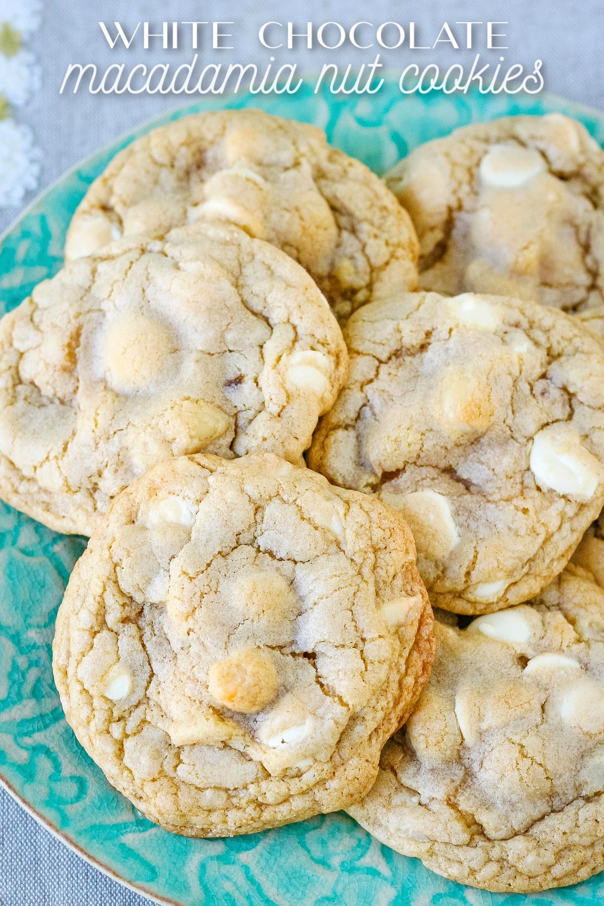 green plate piled with white chocolate macadamia nut cookies and title overlay at top of image