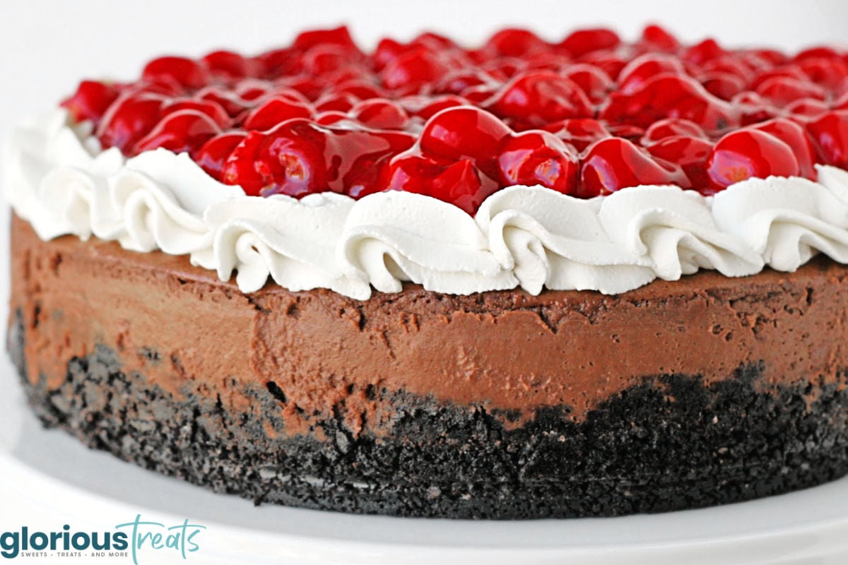 close up look at black forest cheesecake showing the creaminess of the chocolate cheesecake base.