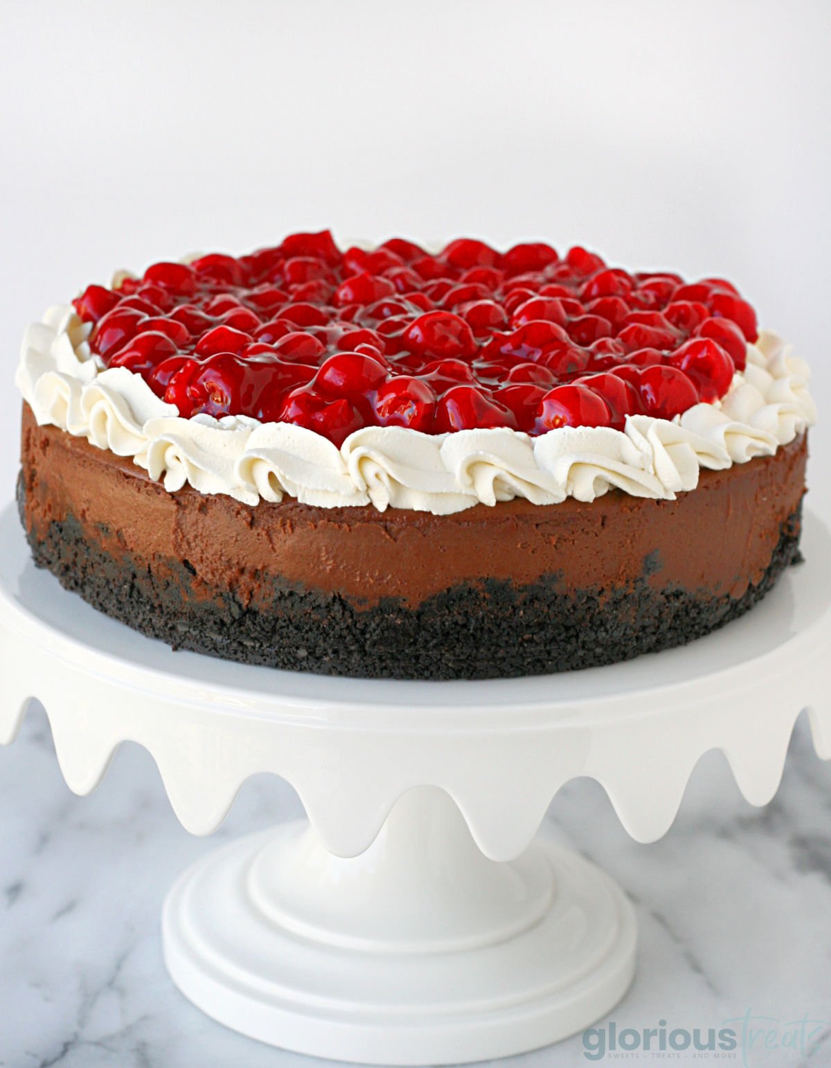 three image collage showing whole black forest cheesecake, a slice on a white plate and a top down view. center color block with text overlay.