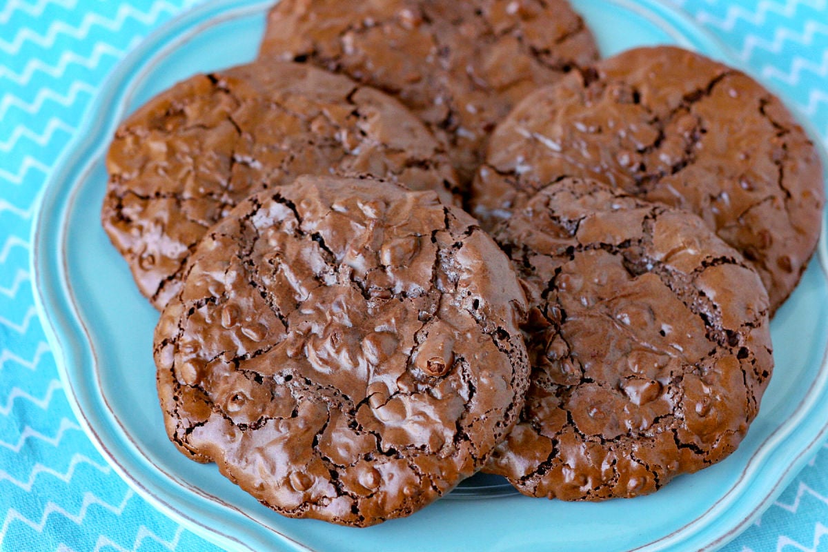 flourless chocolate cookies on blue plate with blue napkin underneath