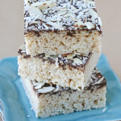 Almond Joy Krispie Treats stacked on a blue plate. - Yes, they are as amazing as they sound!!