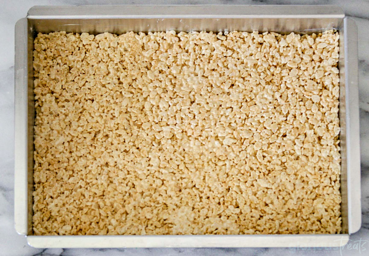 rice krispie treats pressed into a 9 by 13 baking dish.