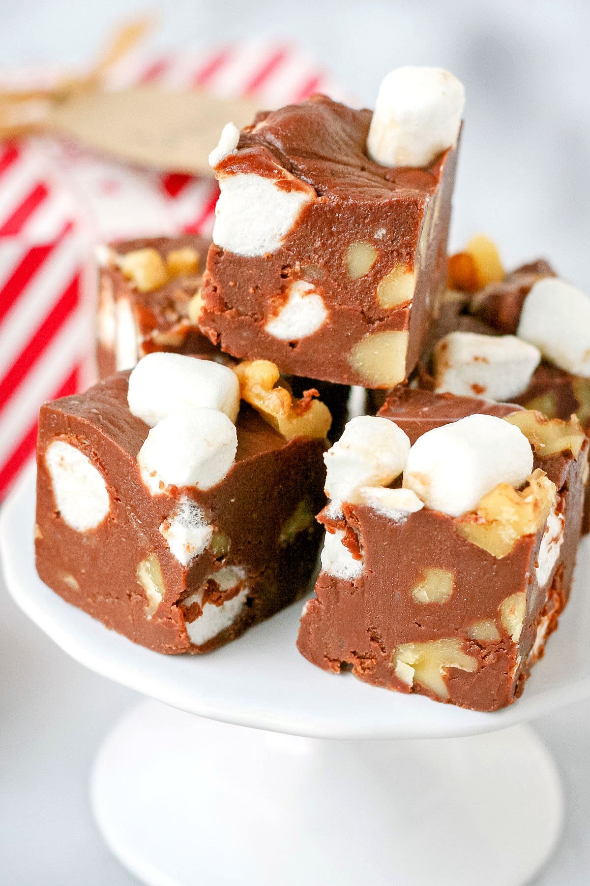 stack of rocky road fudge on white pedestal close up look