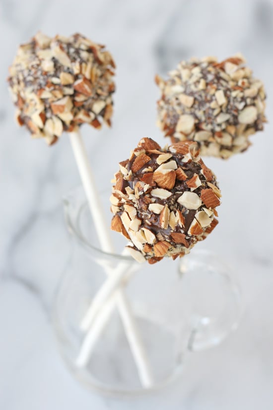 Caramel Nut Crunch Marshmallow Pops - Chocolate, caramel, rice krispies and nuts surround a marshmallow to create an incredible treat! 
