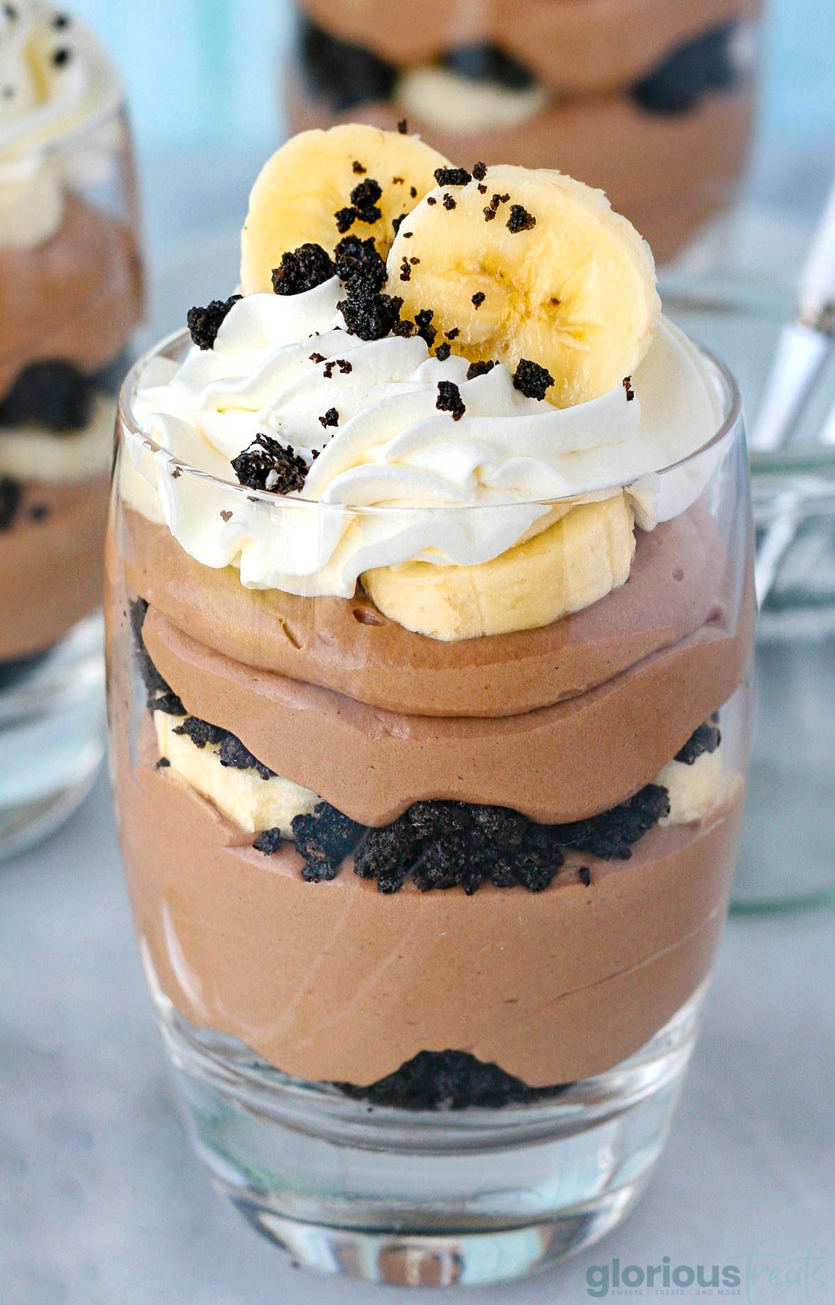 Close up head on banana nutella trifle in glass showing each layer clearly.
