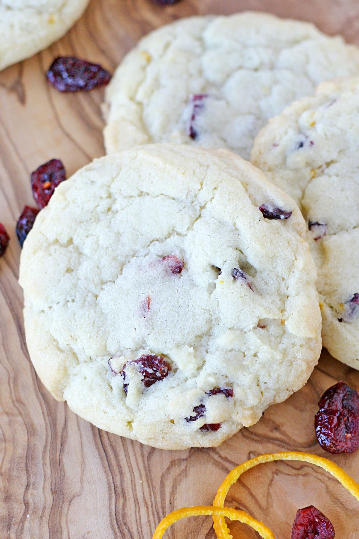 top down view of cranberry orange cookies with dried cranberries scattered around