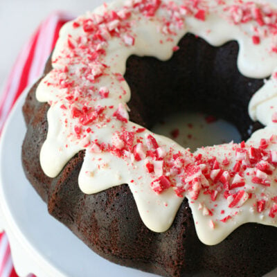 whole chocolate peppermint cake on white cake stand made in a bundt cake pan.