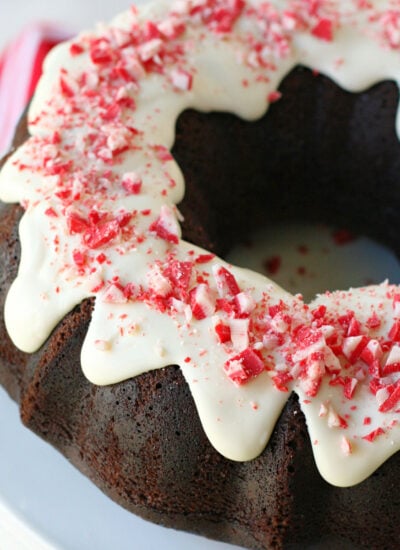 whole chocolate peppermint cake on white cake stand made in a bundt cake pan.