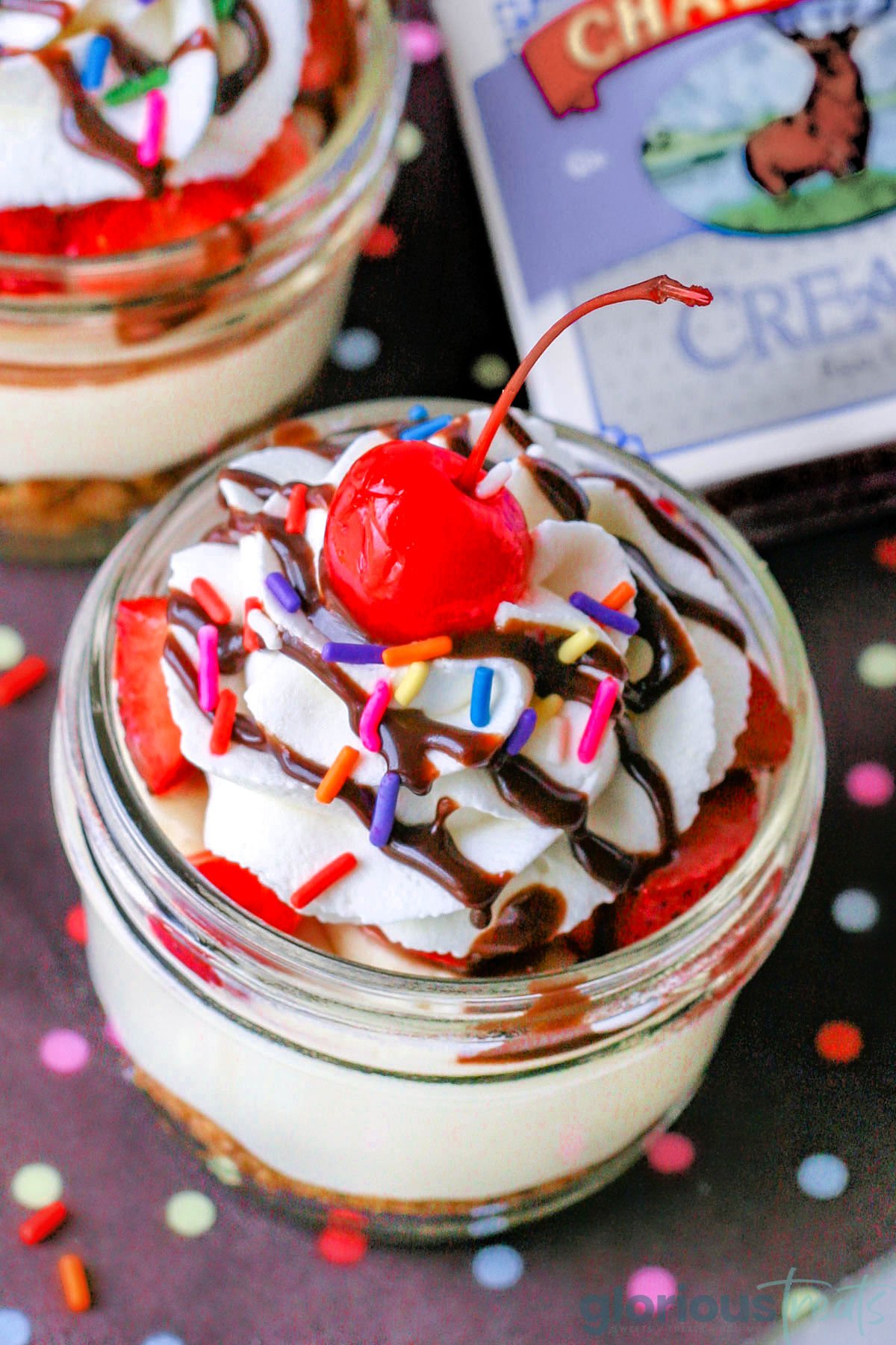 Top down look at banana split no bake cheesecake in small jar topped with classic banana split toppings. 