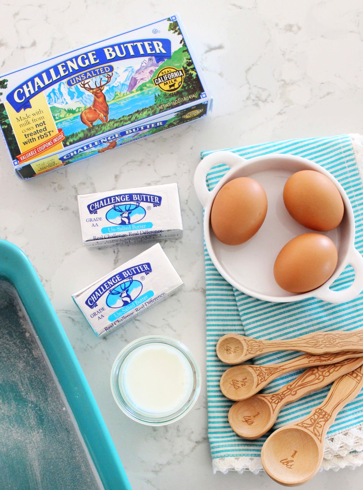 pound cake ingredients laid out on marble surface.