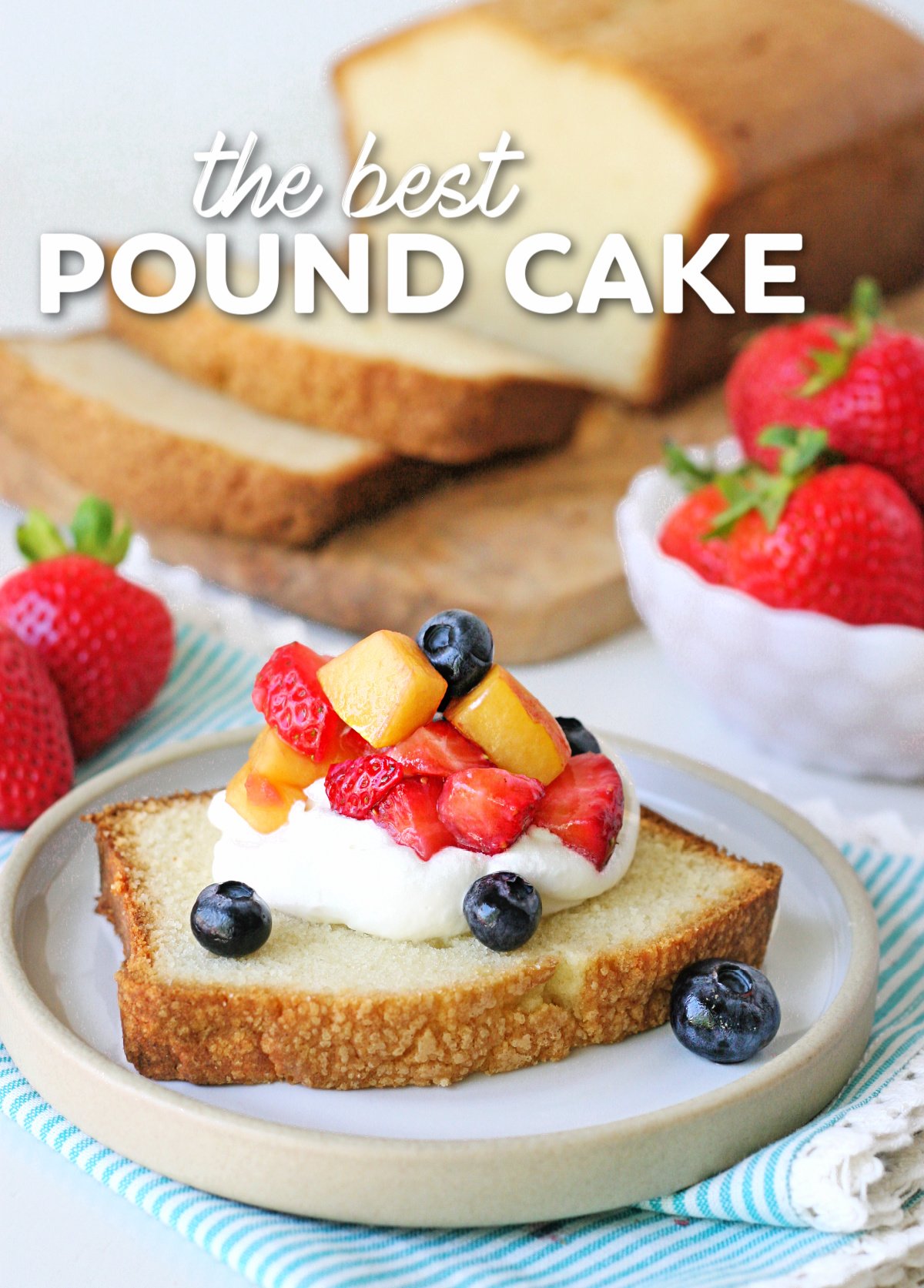 slice of pound cake on plate with whipped cream and berries on top. rest of pound cake on wood board in background. title overlay at top of image.