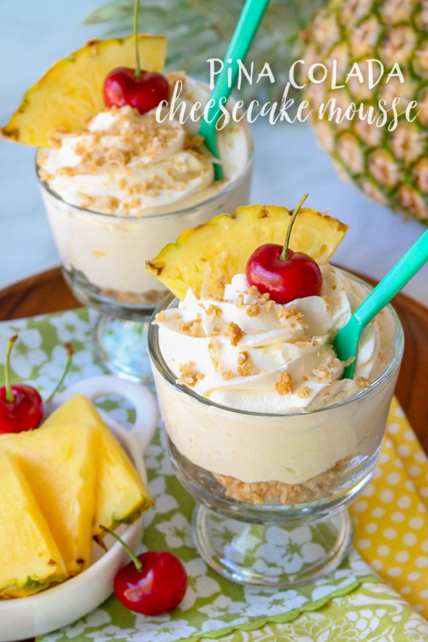 Pina Colada Cheesecake Mousse in glass dishes with cherry and pineapple garnish with text overlay