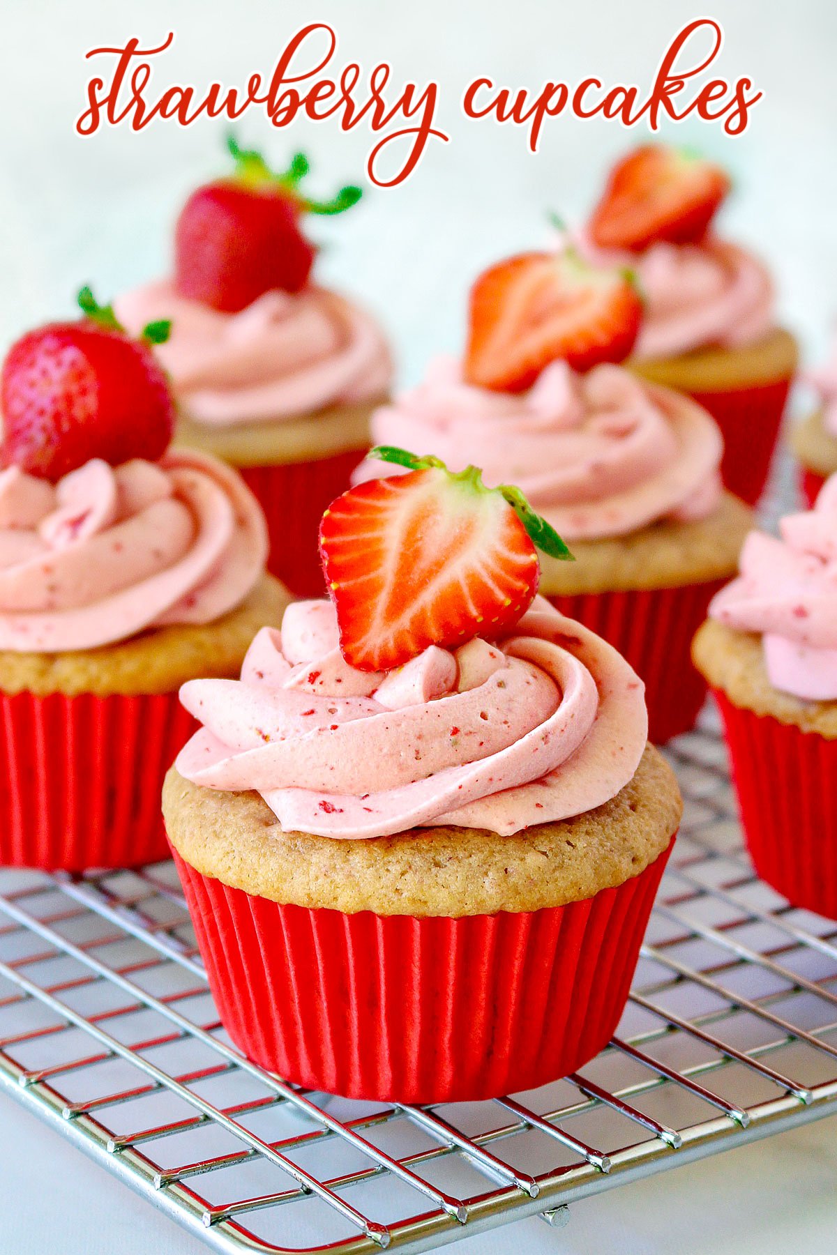 strawberry cupcake recipe on cooling rack with strawberry frosting and title overlay