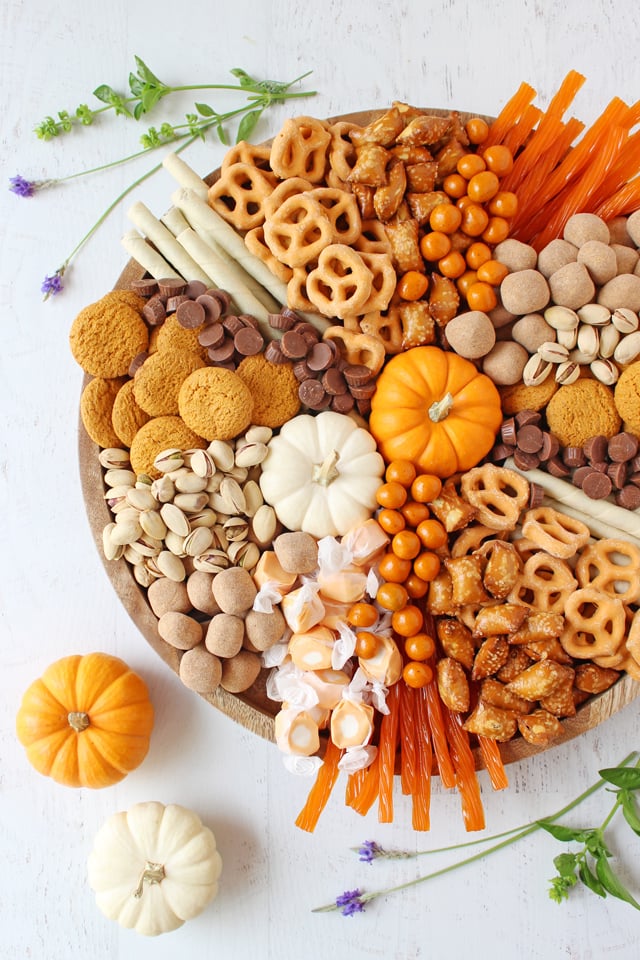 Fall Dessert Charcuterie Board top down view garnished with pumpkins and greenery