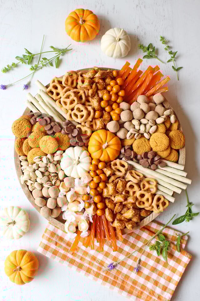 Charcuterie Board with treats and sweets sitting on orange checkered napkin