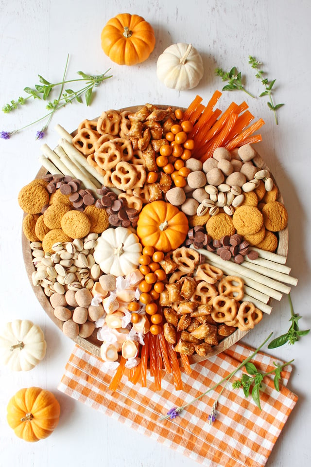 Charcuterie Board with treats and sweets sitting on orange checkered napkin