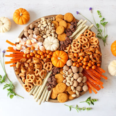 top down view of fall charcuterie board with pumpkins and fall treats