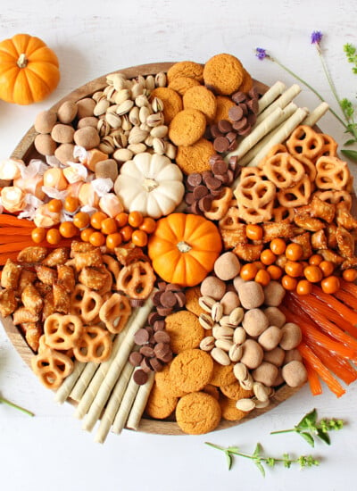 top down view of fall charcuterie board with pumpkins and fall treats