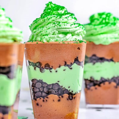 chocolate mint layered dessert in small square plastic cups.