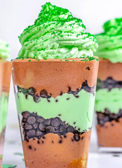 chocolate mint layered dessert in small square plastic cups.