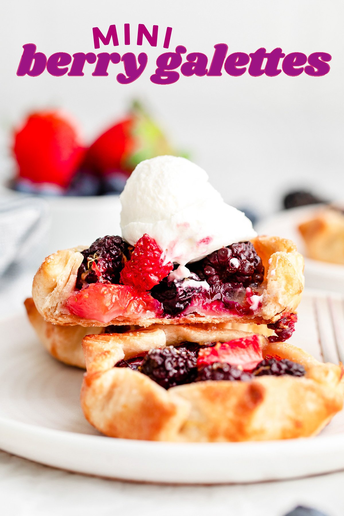 three mini berry galettes on small white plate topped with whipped cream. title overlay at top of image.