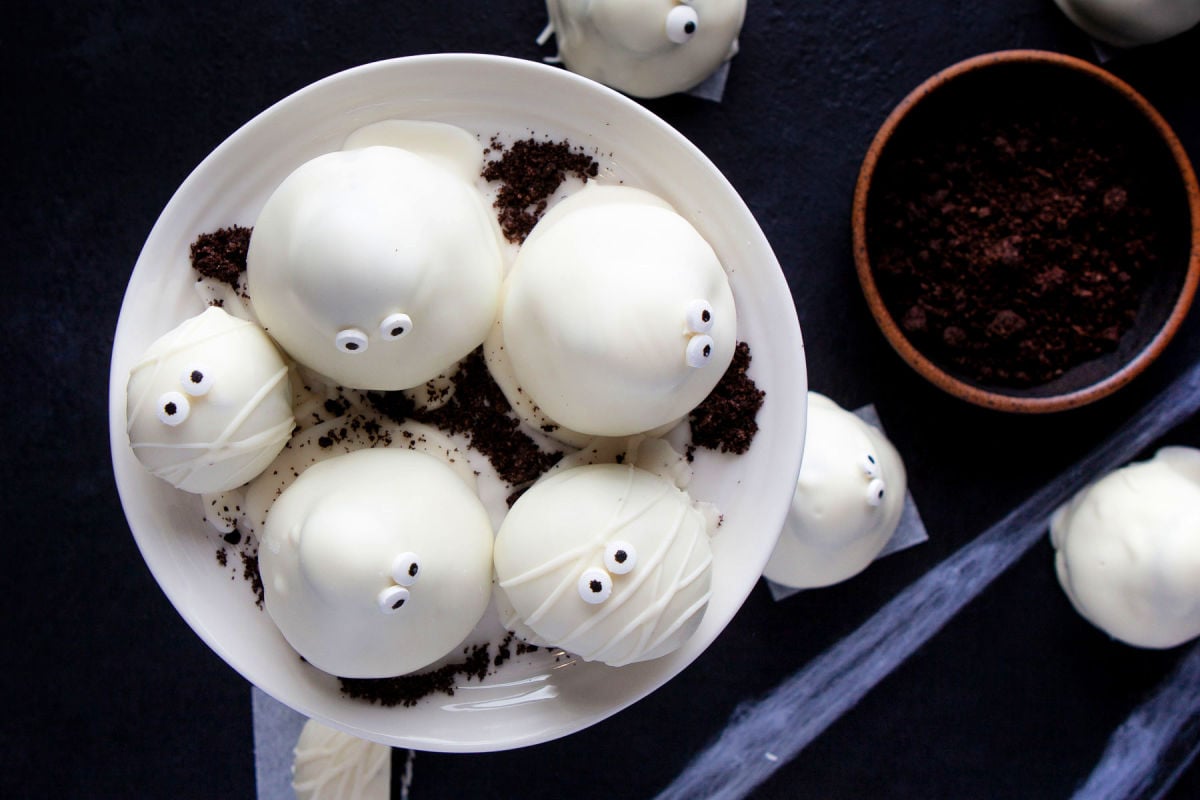 top down look at a handful of oreo truffles on a white cake stand.