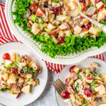 large bowl with waldorf salad in it and three small plates around the bowl that has servings of the salad on the plates.