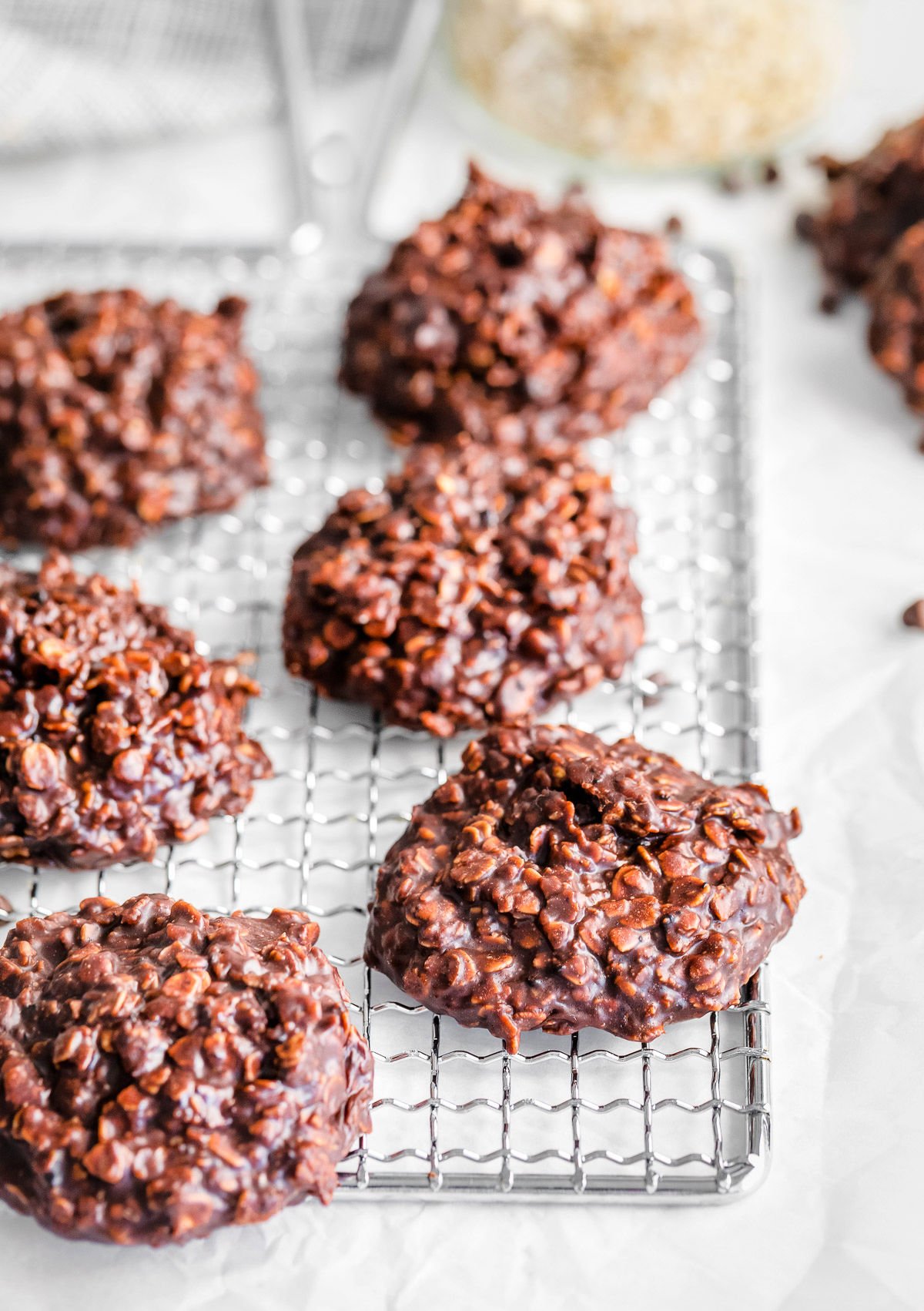 six no bake cookies on a silver wire rack ready to be eaten.