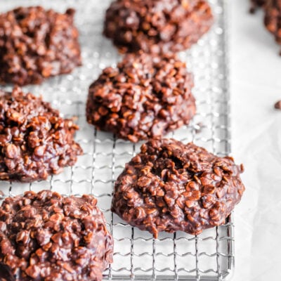 six no bake cookies on a silver wire rack ready to be eaten.