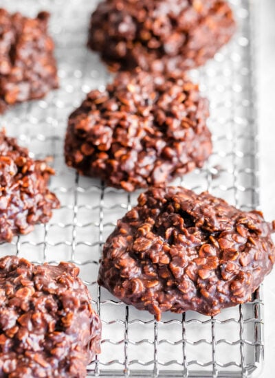 six no bake cookies on a silver wire rack ready to be eaten.